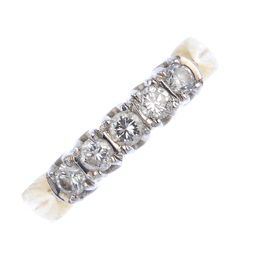 An 18ct gold diamond five-stone ring. The brilliant-cut diamond line, with bar spacers, to the