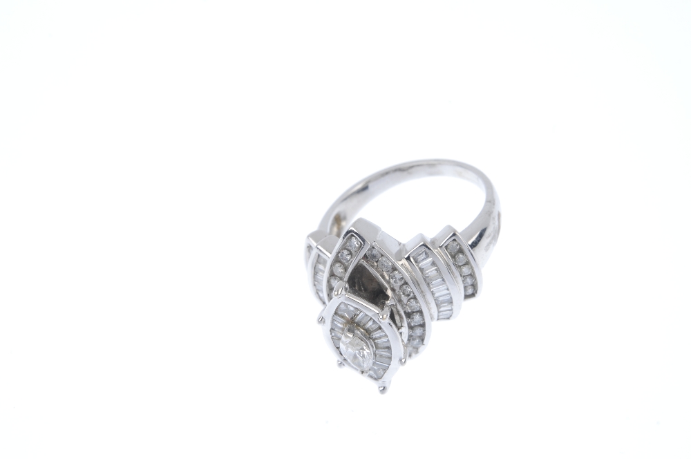 A diamond dress ring. The marquise-shape diamond, within a tapered baguette-cut and square-shape - Image 2 of 4