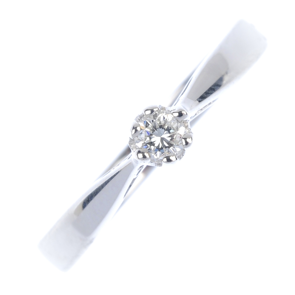 * An 18ct gold diamond single-stone ring. The brilliant-cut diamond, to the tapered shoulders and