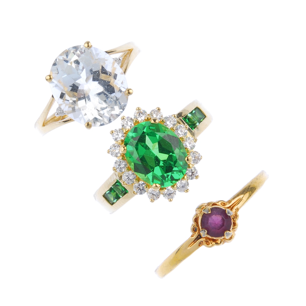 A selection of three gem-set rings. To include an aquamarine single-stone ring, a 14ct gold green