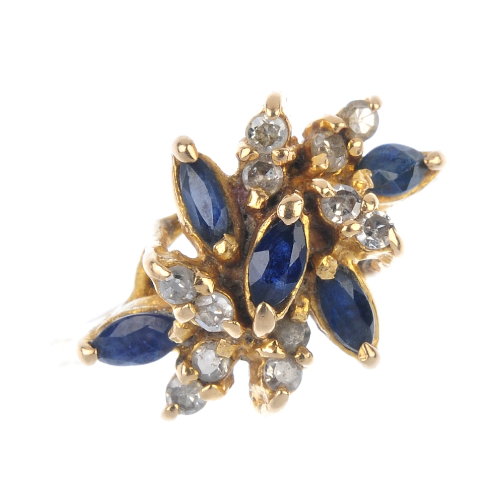 A diamond and sapphire dress ring. The marquise-shape sapphire and brilliant-cut diamond abstract