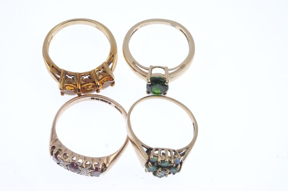 A selection of four 9ct gold gem-set rings. To include a garnet and diamond dress ring, an emerald - Image 2 of 3