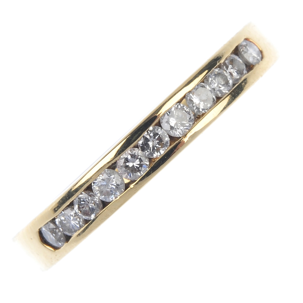 An 18ct gold diamond half-circle eternity ring. The brilliant-cut diamond line, to the plain band.