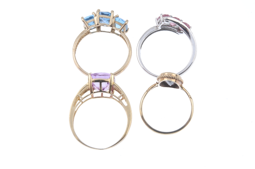 A selection of four 9ct gold gem-set rings. To include a blue topaz three-stone ring, a garnet - Image 3 of 3