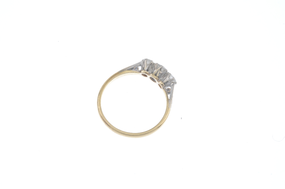 A diamond three-stone ring. The brilliant-cut diamond, with similarly-cut diamond sides, to the - Image 4 of 4