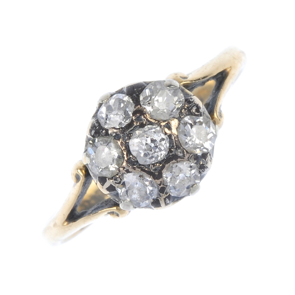 An early 20th century gold diamond cluster ring. The old-cut diamond, within a similarly-cut diamond