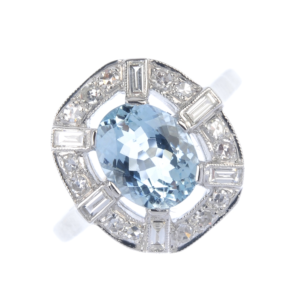 An aquamarine and diamond dress ring. The oval-shape aquamarine, within a single and baguette-cut