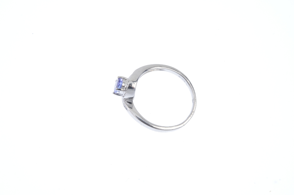 A 9ct gold tanzanite and diamond crossover ring. The oval-shape tanzanite, to the pave-set single- - Image 3 of 4