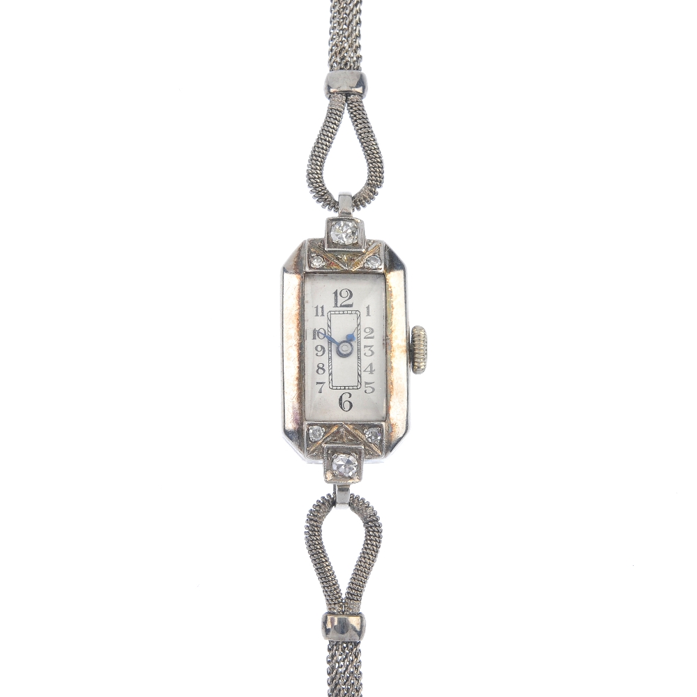 A mid 20th century diamond manual wind cocktail watch. The rectangular-shape white dial with