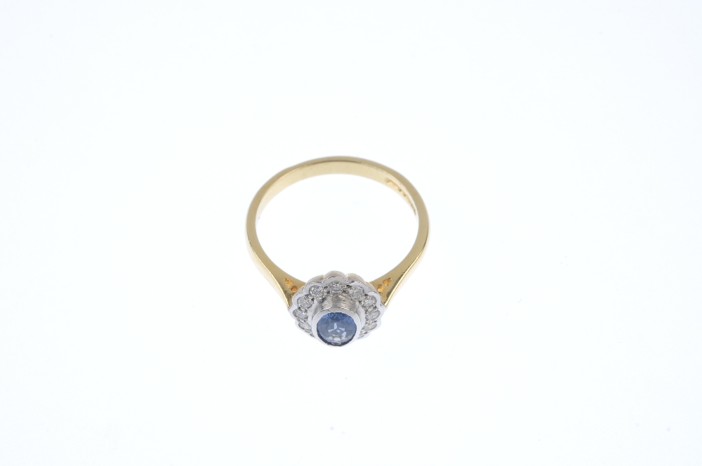 An 18ct gold sapphire and diamond cluster ring. The oval-shape sapphire collet, within a brilliant- - Image 2 of 4