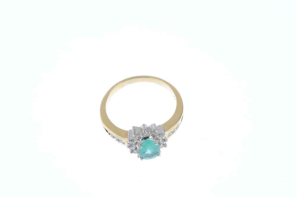 * An 18ct gold emerald and diamond cluster ring. The oval-shape emerald, within a brilliant-cut - Image 2 of 4