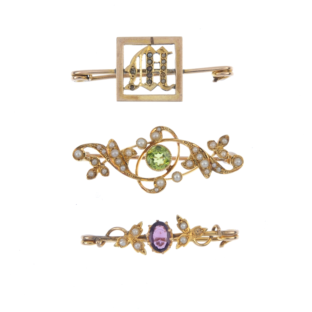 A selection of three early 20th century gold gem-set brooches. To include a peridot and split