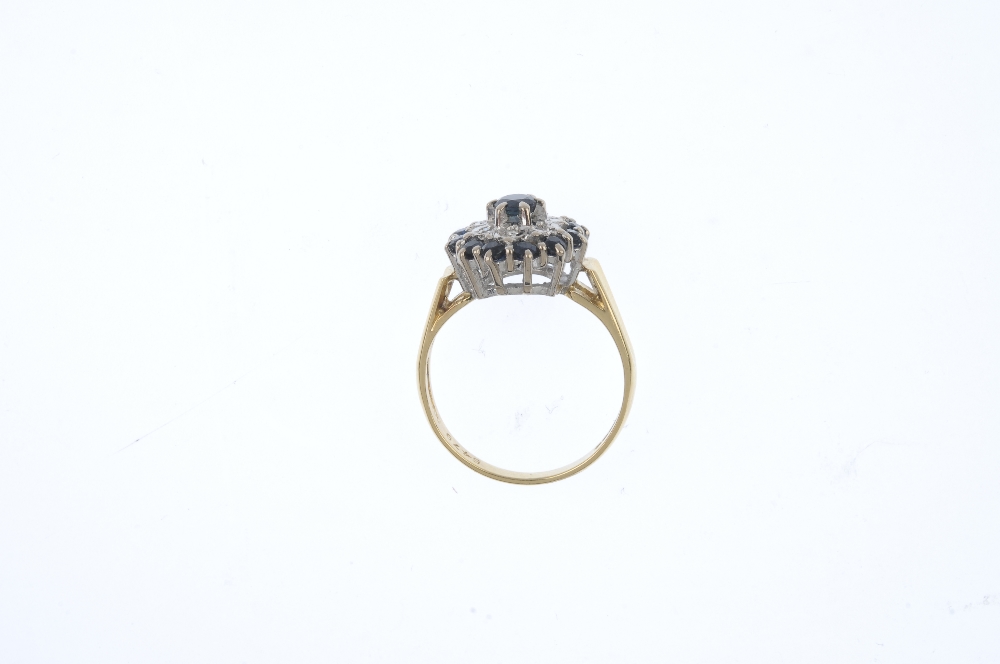 An 18ct gold sapphire and diamond cluster ring. The circular-shape sapphire, raised to the single- - Image 2 of 3