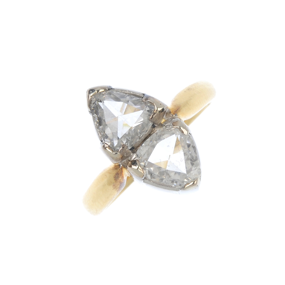 An 18ct gold diamond two-stone ring. The triangular-shape rose-cut diamonds, to the plain band.