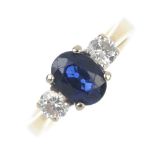 An 18ct gold sapphire and diamond three-stone ring. The oval-shape sapphire, to the brilliant-cut