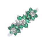 An 18ct gold emerald and diamond triple cluster ring. Of floral design, the three brilliant-cut