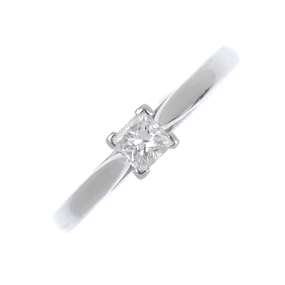 A platinum diamond single-stone ring. The square-shape diamond, to the plain band. Diamond weight