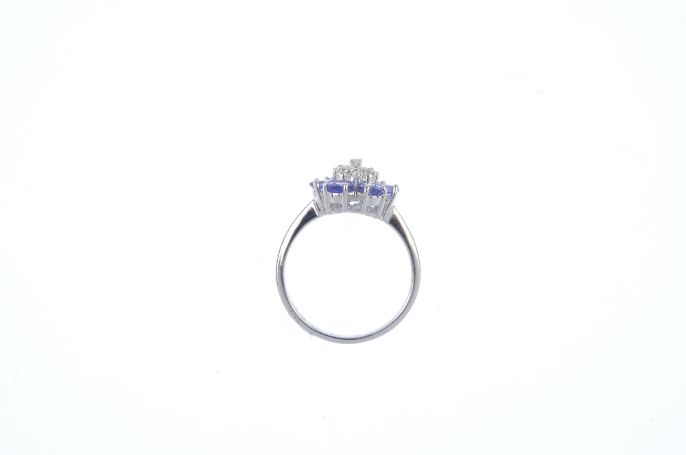 A 9ct gold diamond and tanzanite floral cluster ring. The single-cut diamond cluster, within a - Image 2 of 3