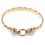 A 9ct gold diamond and gem-set panther bangle. The wrythen bangle, with illusion-set diamond panther