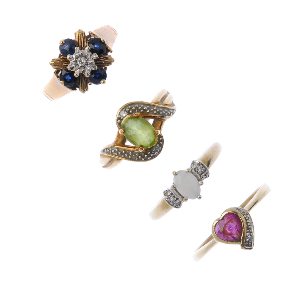 A selection of four diamond and gem-set rings. To include an oval-shape peridot and diamond