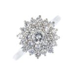 A diamond cluster ring. The brilliant-cut diamond, within a similarly-cut diamond, stepped double