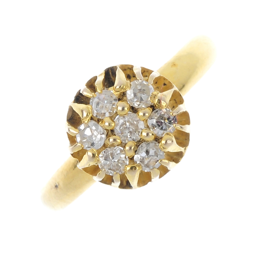 A diamond cluster ring. The circular-cut diamond, within a similarly-cut diamond surround, to the