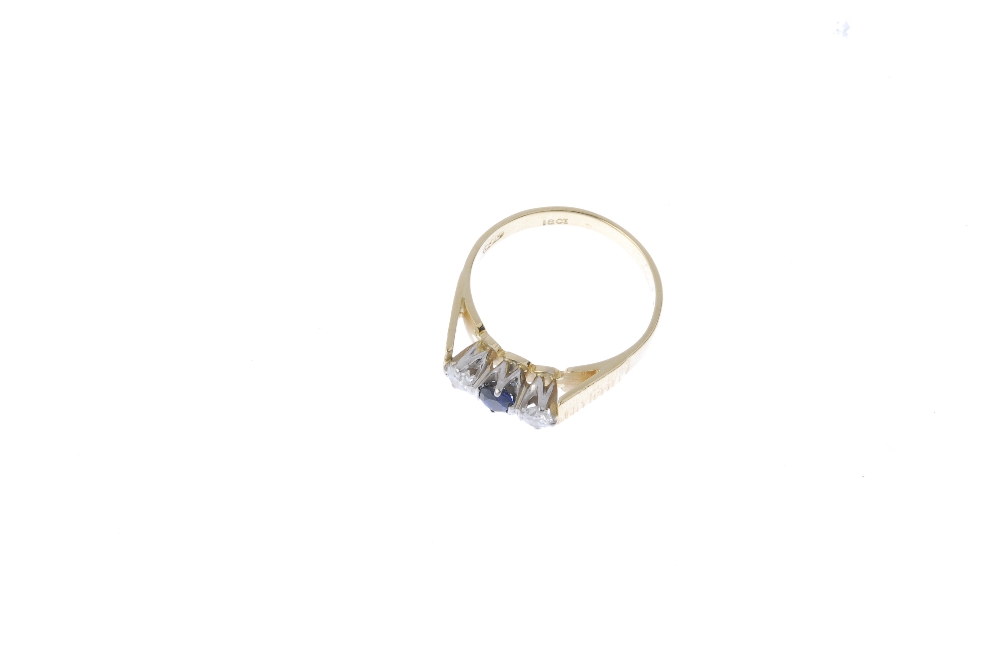 An 18ct gold sapphire and diamond three-stone ring. The circular-shape sapphire and brilliant-cut - Image 2 of 4