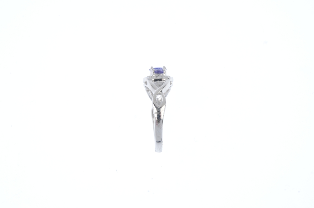 A 9ct gold tanzanite and diamond dress ring. The three oval-shape tanzanite, within a single-cut - Image 3 of 3