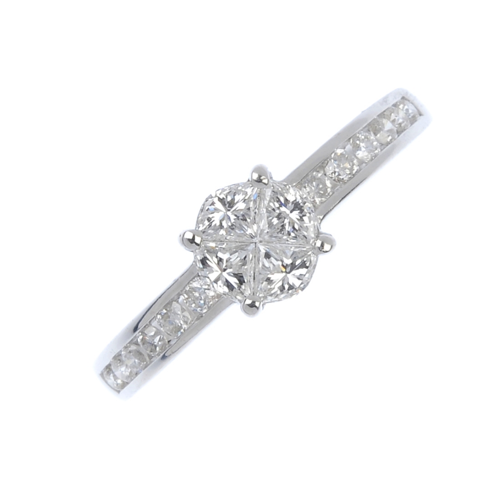 An 18ct gold diamond cluster ring. Designed as a wedge-shape diamond quatrefoil, to the brilliant-