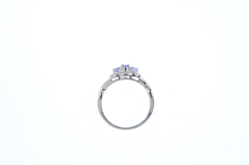 A 9ct gold tanzanite and diamond dress ring. The three oval-shape tanzanite, within a single-cut - Image 2 of 3