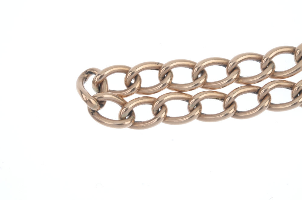 An Edwardian 9ct gold curb-link bracelet. The elongated curb-links, to the padlock clasp. Clasp with - Image 3 of 3