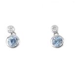 A pair of 18ct gold aquamarine and diamond earrings. Each designed as a circular-shape aquamarine