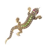 An early 20th century gold and gem-set salamander brooch. The split pearl lizard, with circular-