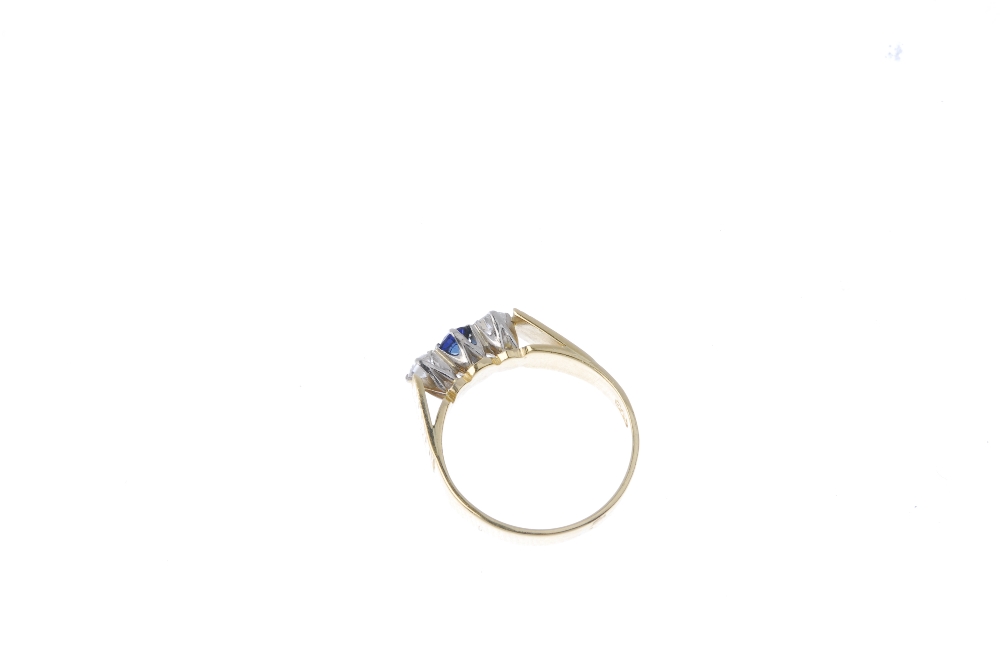 An 18ct gold sapphire and diamond three-stone ring. The circular-shape sapphire and brilliant-cut - Image 4 of 4