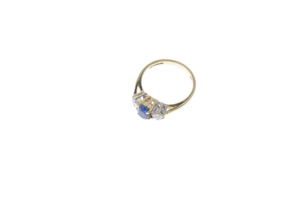 An 18ct gold sapphire and diamond three-stone ring. The oval-shape sapphire. between brilliant-cut - Image 2 of 4