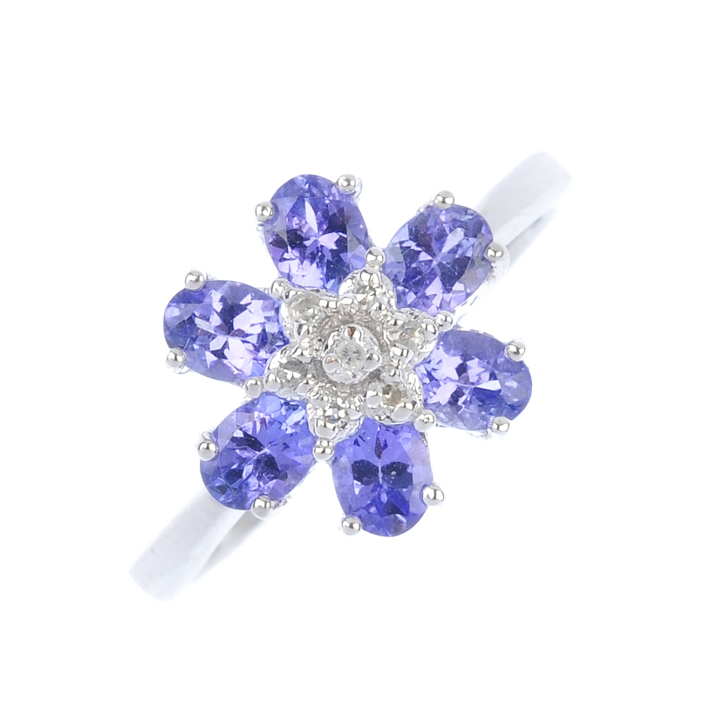 A 9ct gold diamond and tanzanite floral cluster ring. The single-cut diamond cluster, within a
