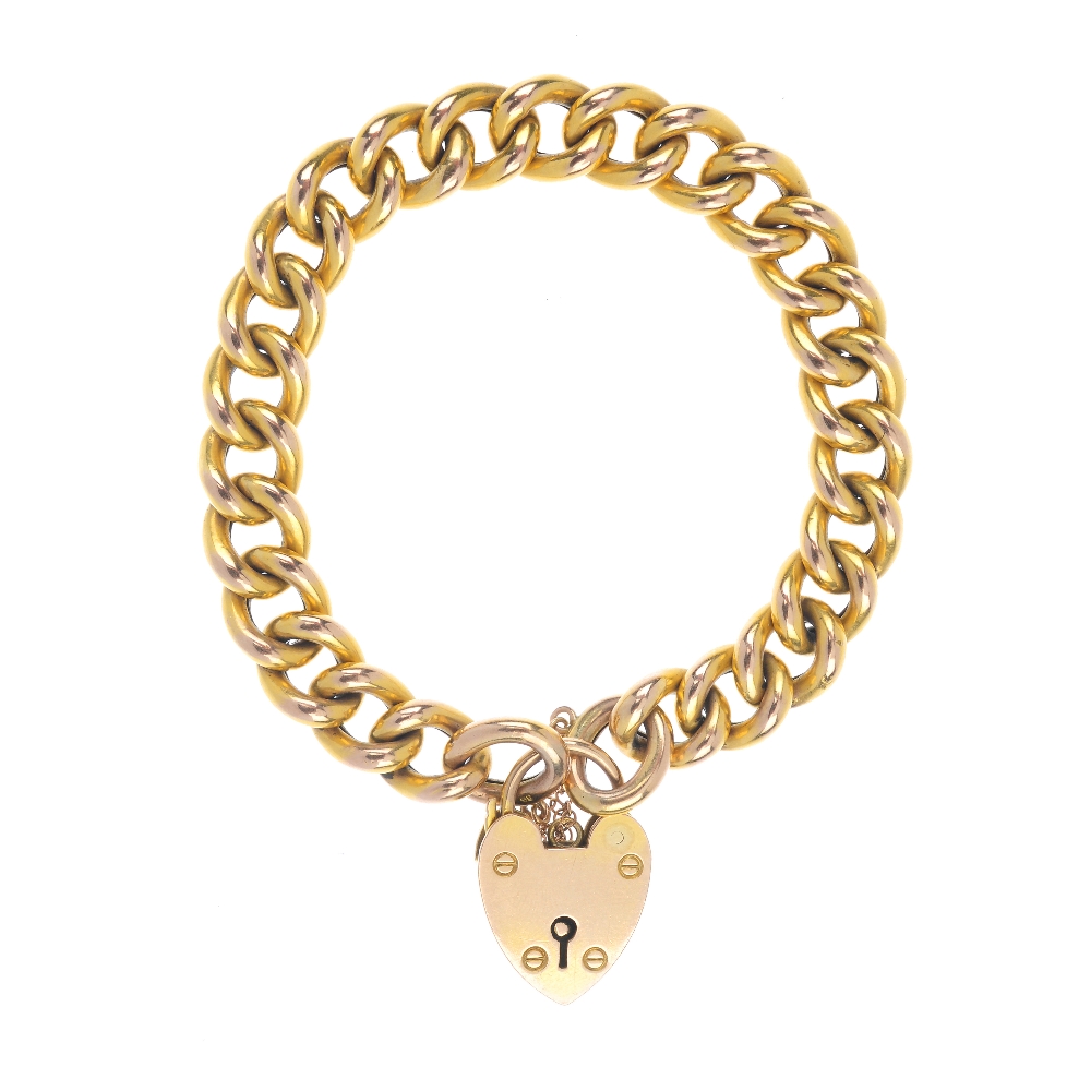 A late 19th century 9ct gold bracelet. The hollow curb-link chain, to the padlock clasp. Length