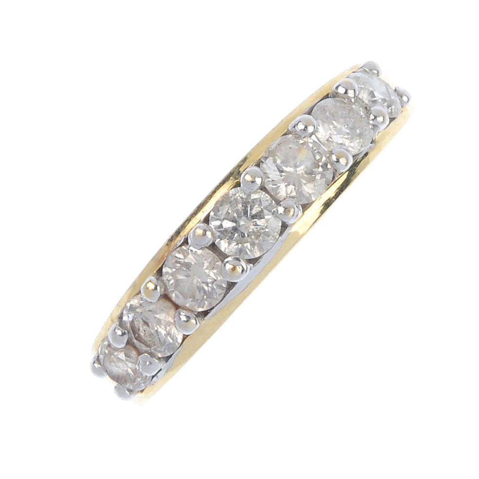 An 18ct gold diamond half-circle eternity ring. The brilliant-cut diamond line, to the tapered band.