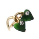 A nephrite jade and diamond dress ring. The two heart-shape nephrite jade panels, each with single-