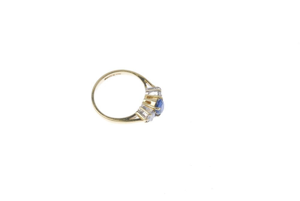 An 18ct gold sapphire and diamond three-stone ring. The oval-shape sapphire. between brilliant-cut - Image 3 of 4