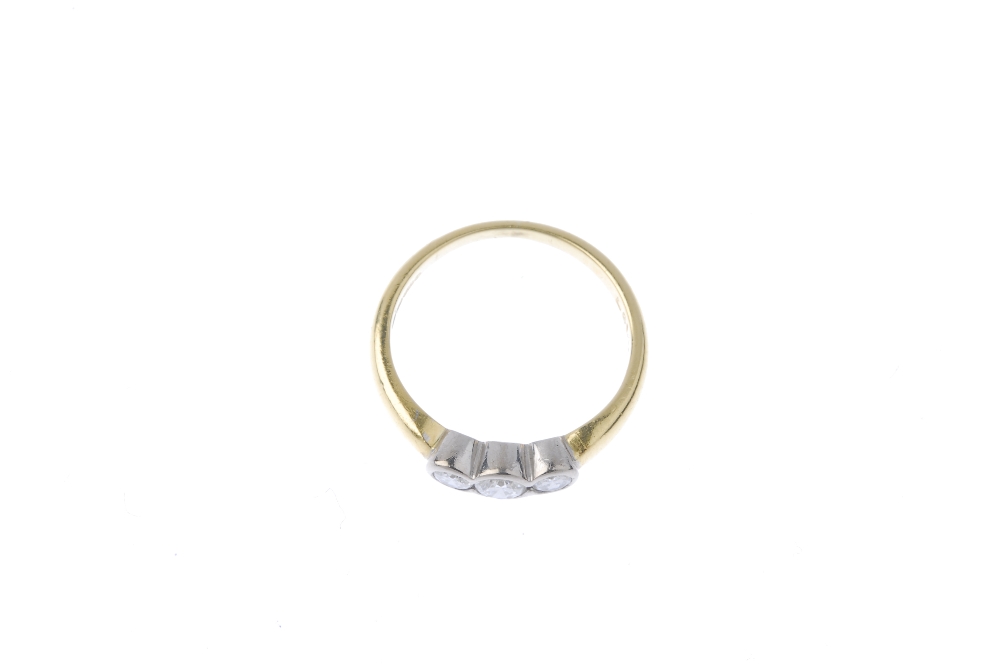 An 18ct gold diamond three-stone ring. Of bi-colour design, the graduated brilliant-cut diamond - Image 4 of 8