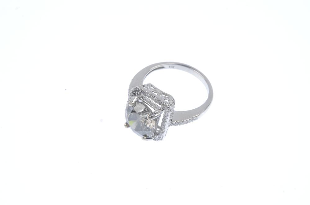 A synthetic diamond and diamond ring. The brilliant-cut synthetic diamond, with single-cut diamond - Image 2 of 4