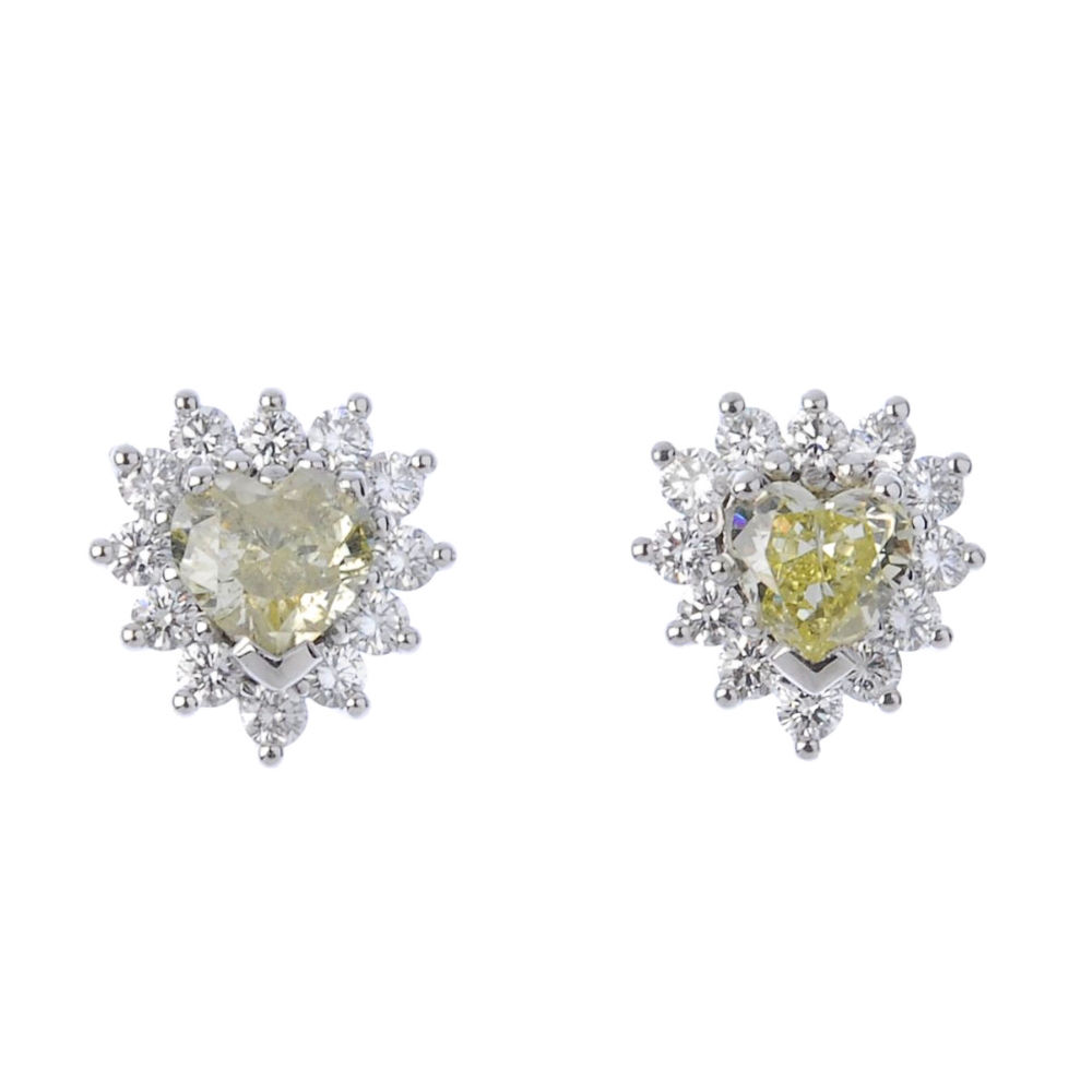 (194424) A pair of 18ct gold coloured diamond and diamond cluster ear studs. Each designed as a