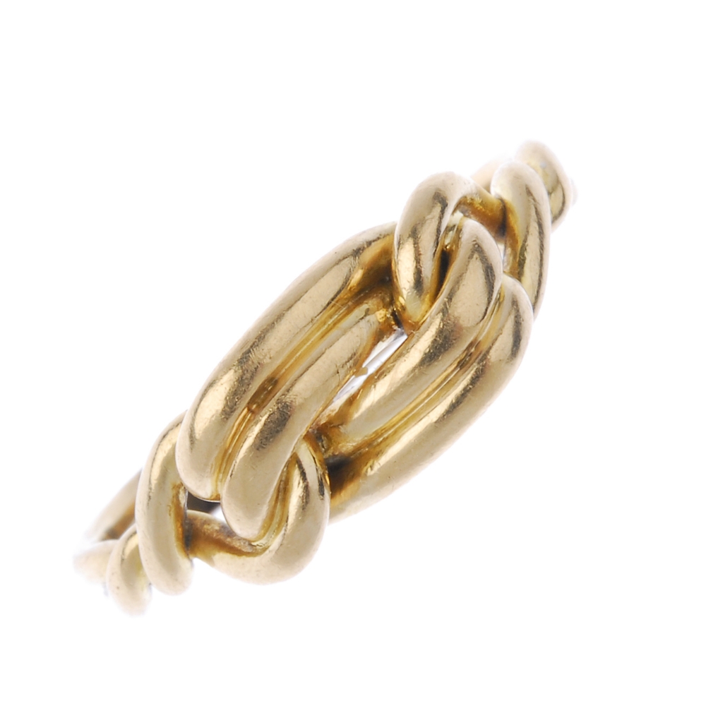 An early 20th century 18ct gold knot ring. Designed as a knot, with crossover shoulders and