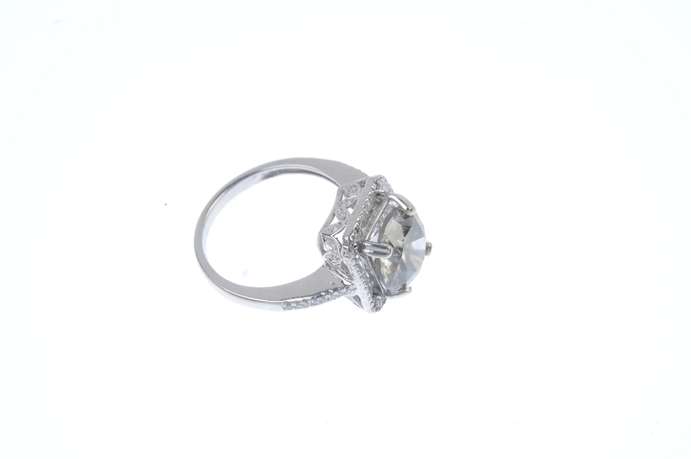 A synthetic diamond and diamond ring. The brilliant-cut synthetic diamond, with single-cut diamond - Image 3 of 4