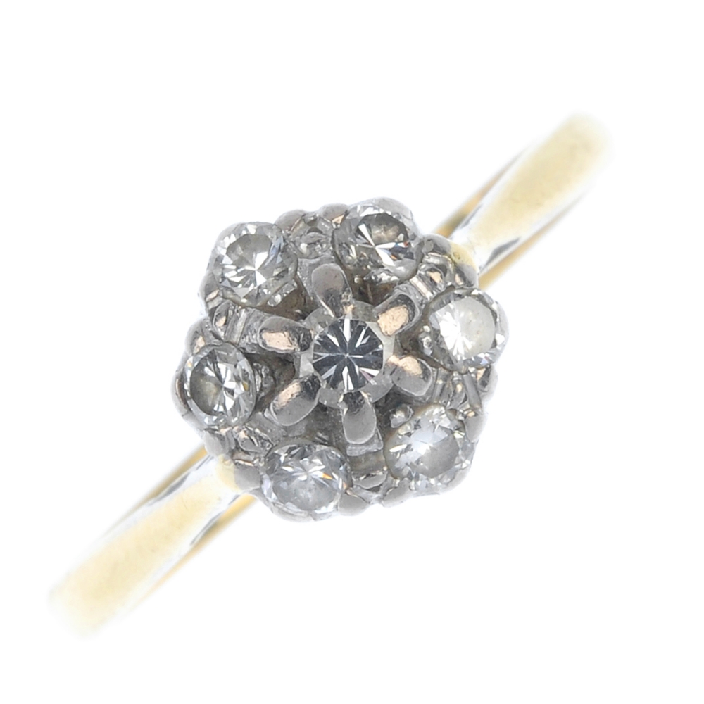 A diamond cluster ring. The brilliant-cut diamond, within a similarly-cut diamond surround, to the