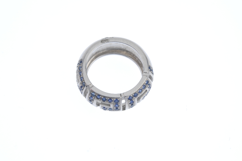 VERSACE - an 18ct gold sapphire band ring. Of openwork design, the circular-shape sapphire Greek-key - Image 2 of 3
