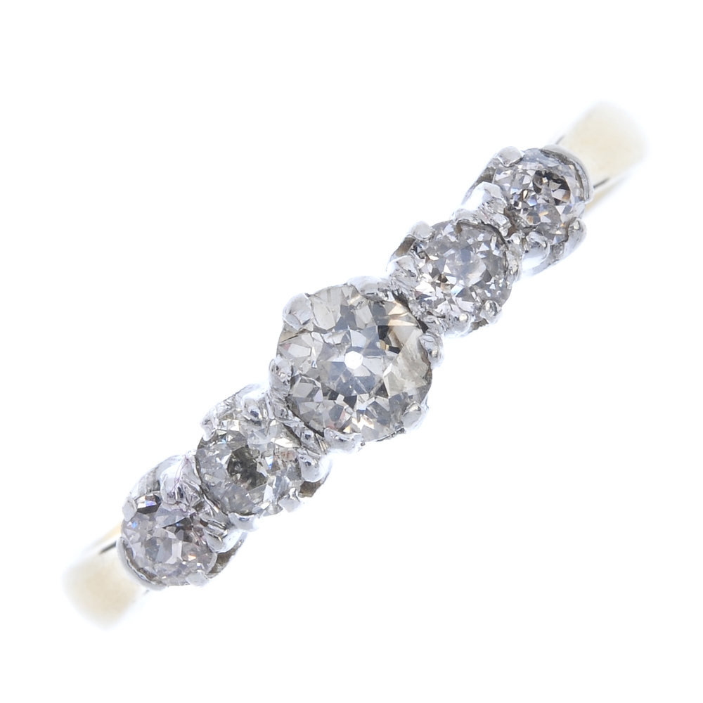 A mid 20th century 18ct gold diamond five-stone ring. The graduated old-cut diamond line, to the