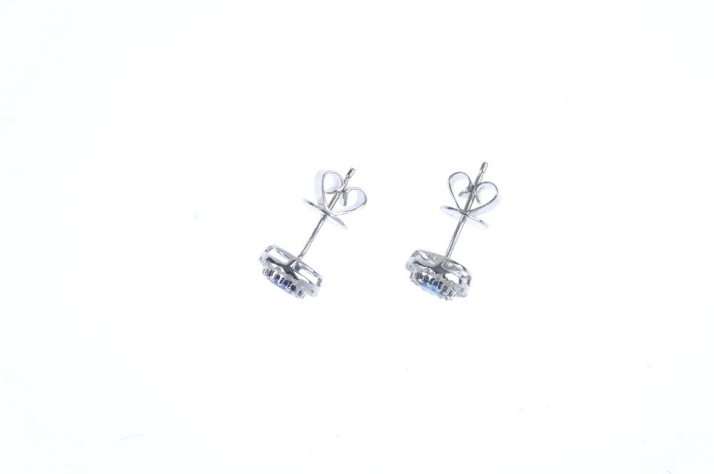 * A pair of sapphire and diamond cluster ear studs. Each designed as an oval-shape sapphire, - Image 2 of 2