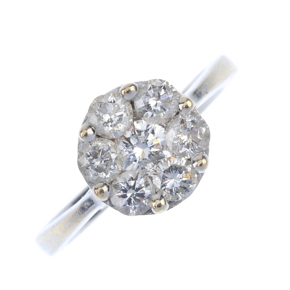 An 18ct gold diamond cluster ring. The brilliant-cut diamond, within a similarly-cut diamond